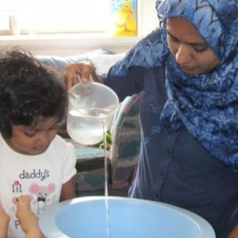 mom-daughter-pouring-water